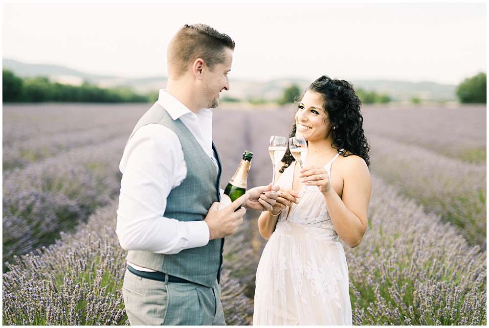 engagement session in lavander of provence with champagne